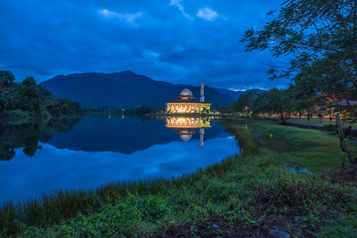 Scenic view of lake against sky at night