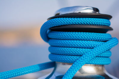 Close-up of blue rope attached to bollard