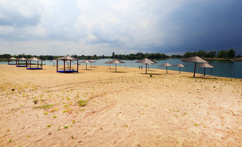 Scenic view of beach against cloudy sky