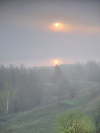 Scenic view of field against sky during sunset