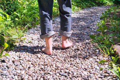 Low section of person standing on rock