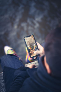 Man photographing on mobile phone