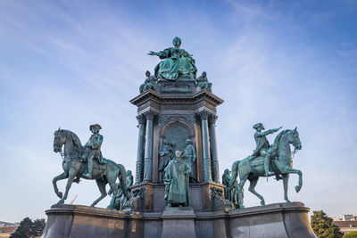 Low angle view of statue against blue sky