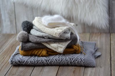 Close-up sweaters folded on wooden table