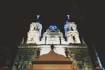 Low angle view of illuminated building against sky at night