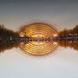 Reflection of trees in water against sky