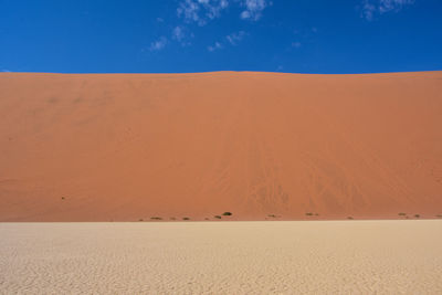 Scenic view of desert against blue sky