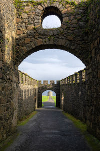 Archway of old building against sky