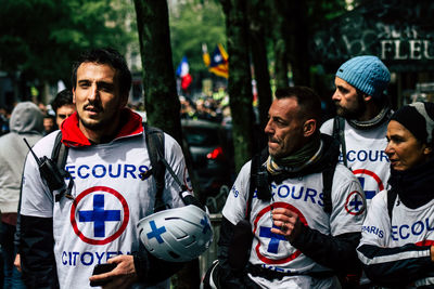 Young man standing with people in background