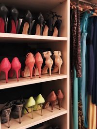 High heels and clothes in cupboard at home