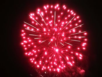 Low angle view of firework display at night