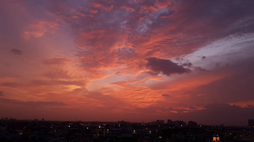Silhouette buildings against sky during sunset