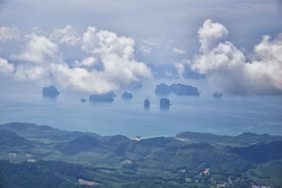 Scenic view of land and mountains against sky