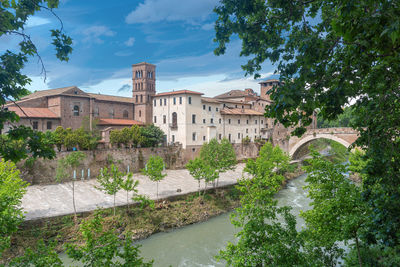 Arch bridge and buildings against sky in city