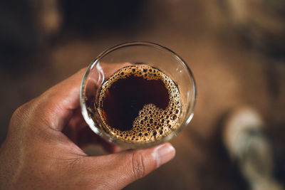 Close-up of hand holding coffee cup