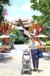 Full length of women with plants in foreground