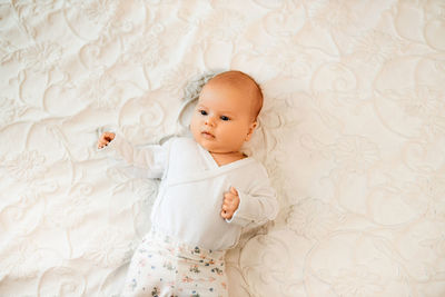 Cute baby boy sleeping on bed