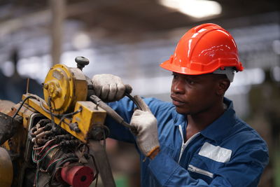 Rear view of man working in factory