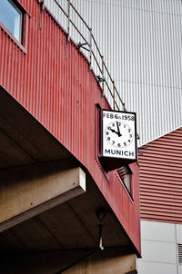 Low angle view of information sign on wall of building