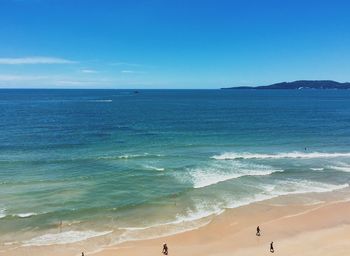 Scenic view of beach against blue sky