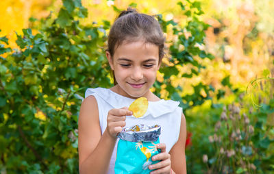 Cute girl eating potato chip