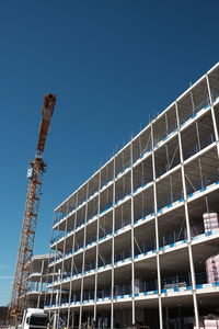 Low angle view of construction site against clear sky