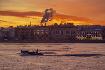 Ship in sea at sunset