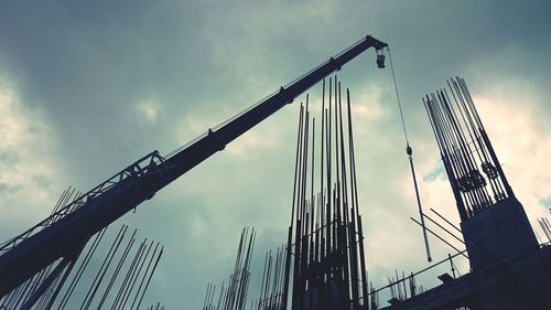 Low angle view of crane against sky