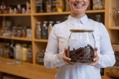 Midsection of woman holding ice cream