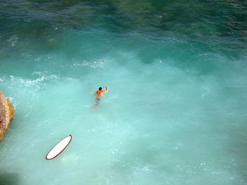 High angle view of people swimming in sea