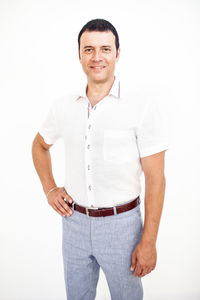 Portrait of smiling man standing against white background