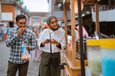 Portrait of young woman using mobile phone