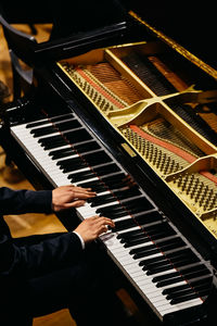 Midsection of man playing piano