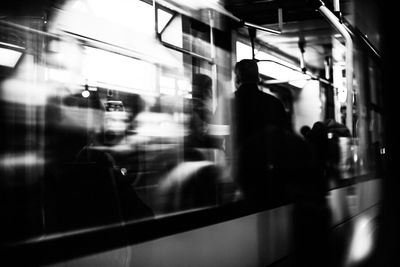 Blurred motion of people and train at railroad station platform