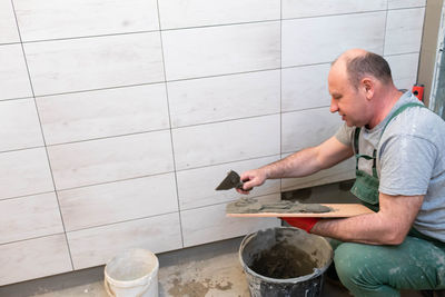 Side view of man working in kitchen