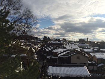 Buildings against cloudy sky