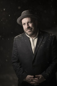 Portrait of man wearing hat standing outdoors