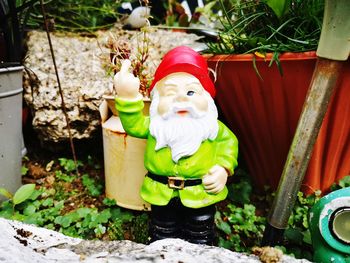 Stuffed toy by potted plant in yard