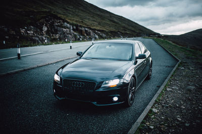 Car on road against mountain range