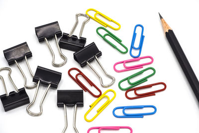 Close-up of colored pencils over white background