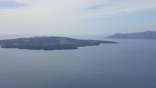 Scenic view of sea and mountains against sky