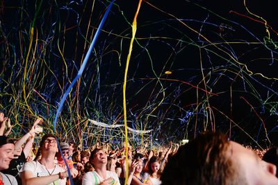 Crowd of happy fans cheering at event 