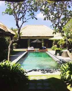 Built structure by swimming pool against sky