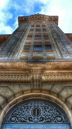 Low angle view of building against cloudy sky