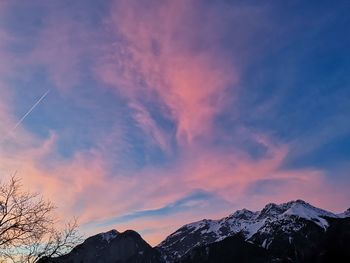 Scenic view of snowcapped mountains against sky during sunset