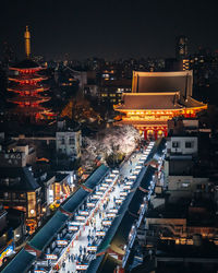 High angle view of illuminated buildings in city at night