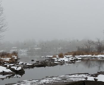 Scenic view of frozen lake against sky