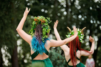 Rear view of woman standing by plants