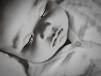 Close-up portrait of baby lying on bed