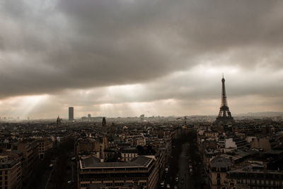 Aerial view of city against cloudy sky